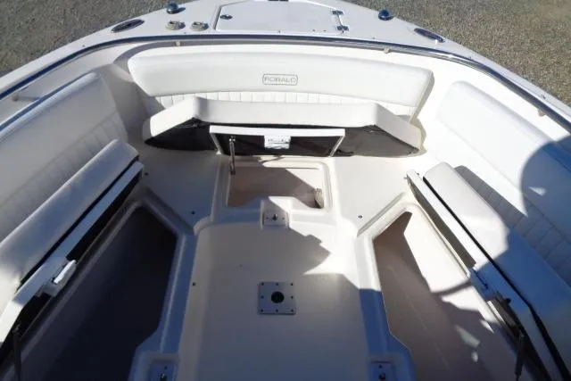 Slide: The Image of 2015 Robalo R247 Dual Console boat interior with spacious seating and storage compartments. - 17