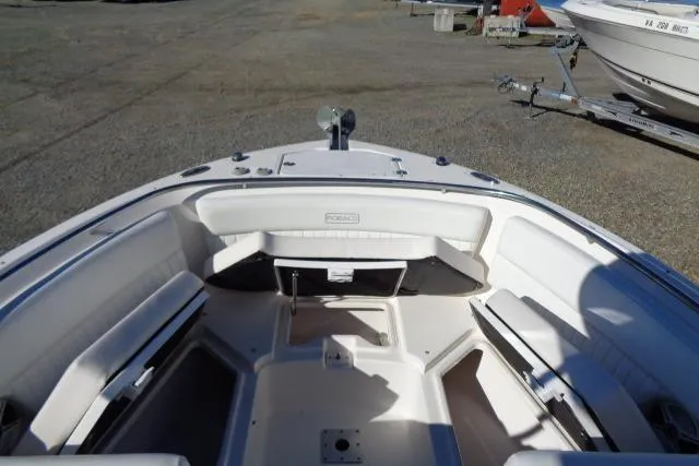 Slide: The Image of 2015 Robalo R247 Dual Console boat interior with seating and storage compartments. - 18