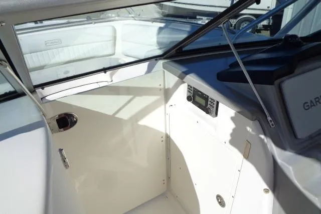 Slide: The Image of 2015 Robalo R247 Dual Console boat interior with control panel and seating area. - 24