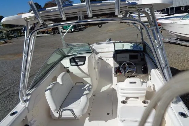 Slide: The Image of 2015 Robalo R247 Dual Console boat interior with seating and steering console. - 28