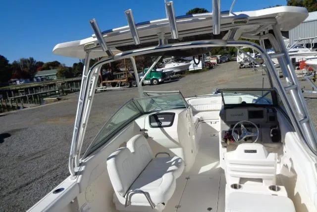 Slide: The Image of 2015 Robalo R247 Dual Console boat with spacious seating and modern dashboard. - 29