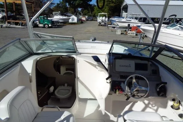 Slide: The Image of 2015 Robalo R247 Dual Console boat interior with Garmin navigation system and toilet. - 31