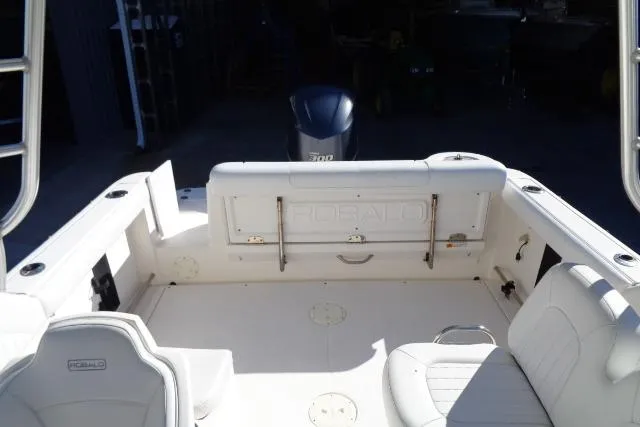 Slide: The Image of 2015 Robalo R247 Dual Console boat interior with seating and engine view. - 33