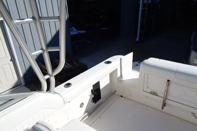 Slide: The Image of 2015 Robalo R247 Dual Console boat interior, featuring seating and storage compartments. - 35