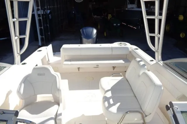 Slide: The Image of 2015 Robalo R247 Dual Console boat interior with white seating and spacious layout. - 37