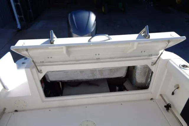 Slide: The Image of 2015 Robalo R247 Dual Console boat with open storage compartment. - 39