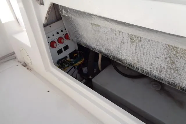 Slide: The Image of 2015 Robalo R247 Dual Console boat interior showing electrical panel and wiring. - 40