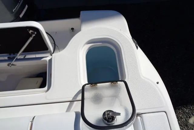 Slide: The Image of 2015 Robalo R247 Dual Console boat with open storage compartment and livewell. - 43