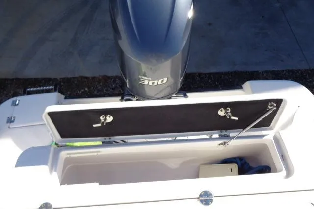 Slide: The Image of 2015 Robalo R247 Dual Console boat with open storage compartment and Yamaha 300 engine. - 44