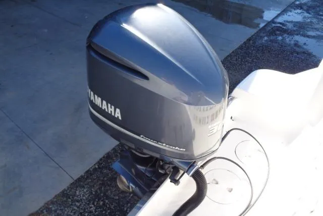Slide: The Image of 2015 Robalo R247 Dual Console with Yamaha outboard motor, docked on concrete surface. - 45