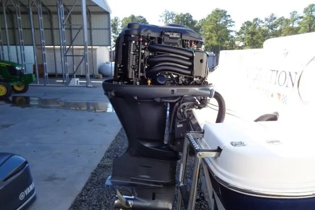 Slide: The Image of 2015 Robalo R247 Dual Console with Yamaha outboard engine in a marina setting. - 46