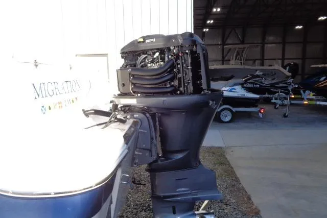 Slide: The Image of 2015 Robalo R247 Dual Console boat with outboard motor in a storage facility. - 47