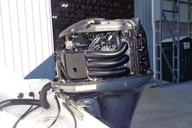 Slide: The Image of 2015 Robalo R247 Dual Console boat engine in a storage facility. - 48