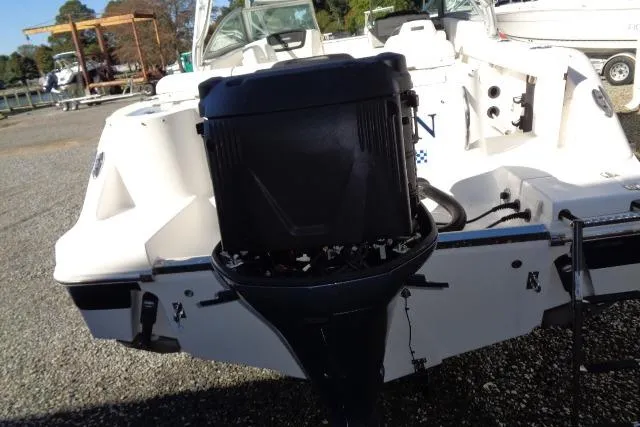 Slide: The Image of 2015 Robalo R247 Dual Console boat with outboard motor, parked on gravel. - 49