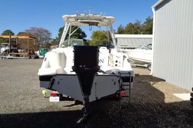 Slide: The Image of 2015 Robalo R247 Dual Console boat, rear view, parked outdoors near a storage facility. - 51