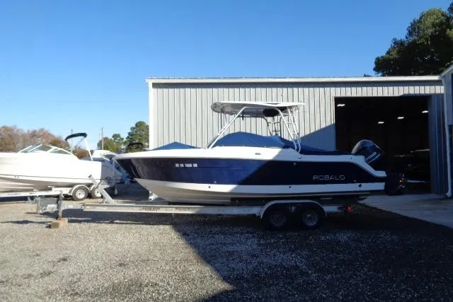 Slide: The Image of 2015 Robalo R247 Dual Console boat on trailer outside storage facility. - 8