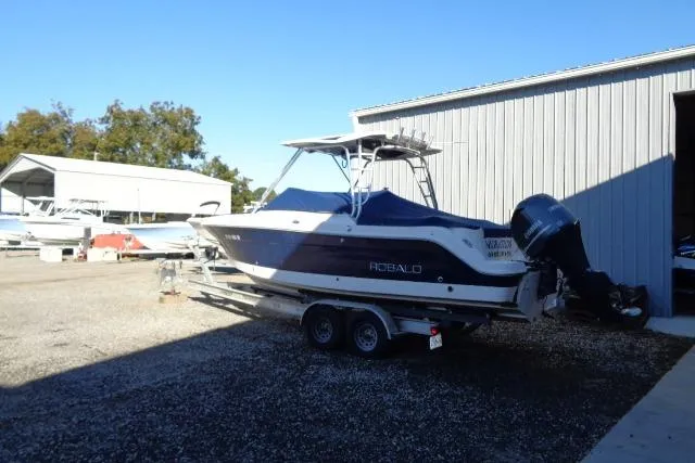 Slide: The Image of 2015 Robalo R247 Dual Console boat on trailer near storage facility. - 9