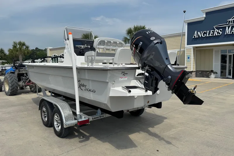 Slide: The Image of 2025 BayRider 2060 boat on trailer, parked outside Anglers Marine store. - 3
