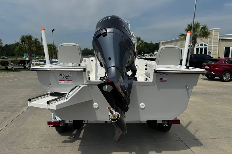 Slide: The Image of 2025 BayRider 2060 boat with outboard motor, parked outdoors on a sunny day. - 4