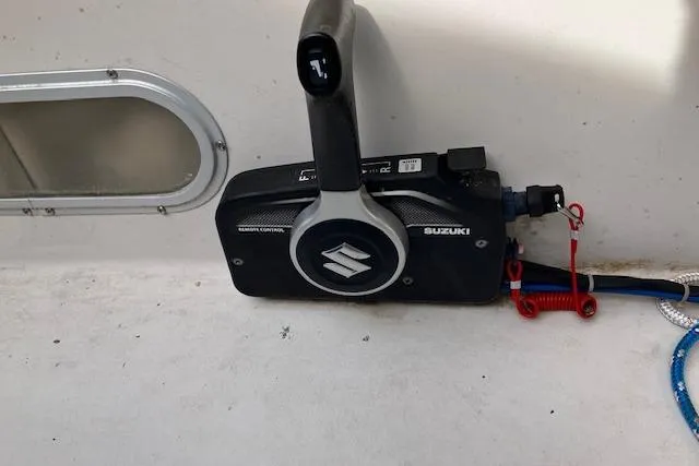 Slide: The Image of Suzuki remote control on a 1979 Chrysler 26 boat, featuring throttle and gear lever. - 11