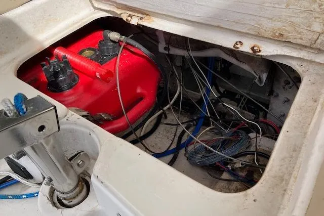 Slide: The Image of 1979 Chrysler 26 boat engine compartment with red fuel tank and wiring. - 14