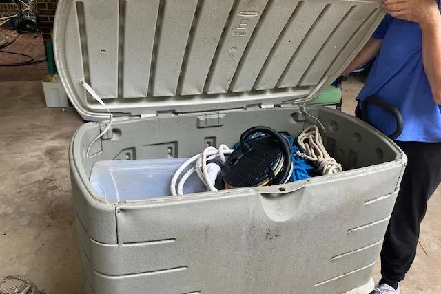 Slide: The Image of Open storage box with ropes and equipment, person in blue shirt nearby. - 16
