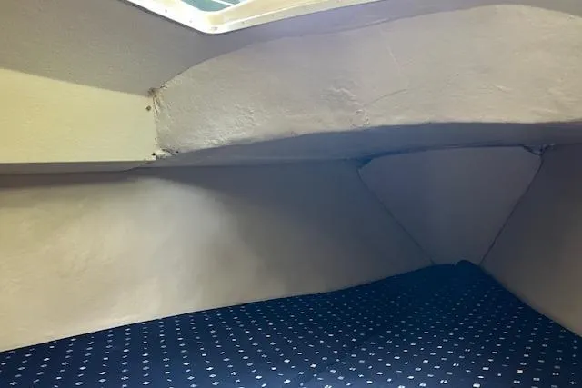 Slide: The Image of Interior cabin of a 1979 Chrysler 26 sailboat with a patterned cushion. - 28