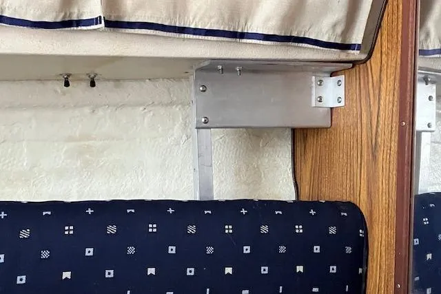 Slide: The Image of 1979 Chrysler 26 interior detail with patterned upholstery and metal bracket. - 32