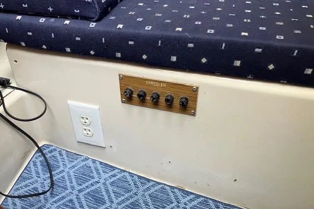 Slide: The Image of 1979 Chrysler 26 interior with control panel, patterned upholstery, and electrical outlet. - 33