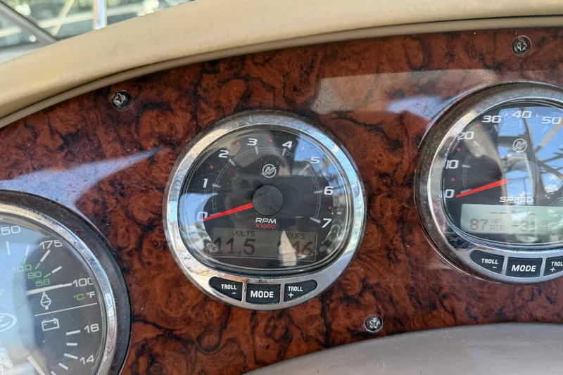 Slide: The Image of Dashboard of a 2004 Sea Ray 280 Sundancer boat with RPM and speed gauges. - 17