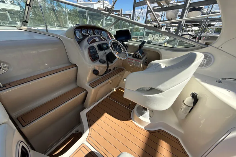 Slide: The Image of 2004 Sea Ray 280 Sundancer helm with modern controls and comfortable seating. - 4