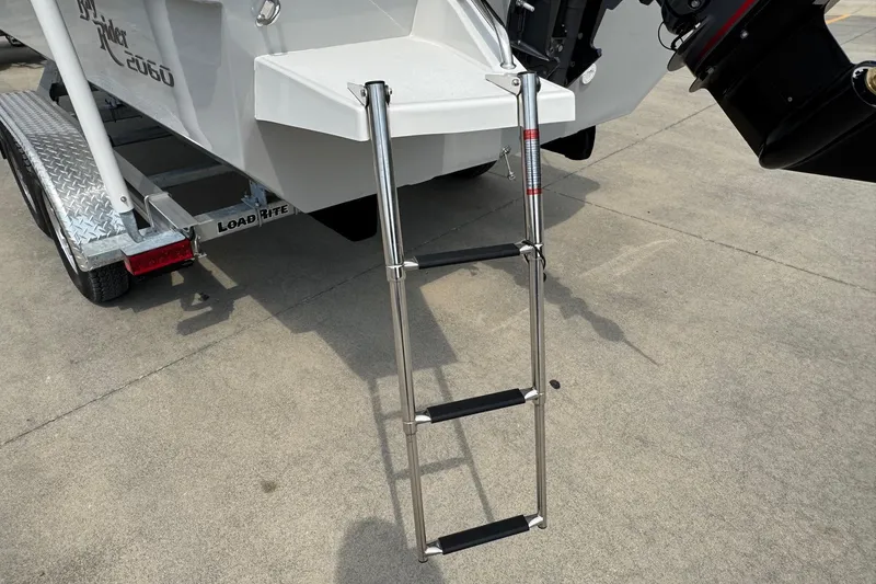 Slide: The Image of Bay Rider 2060 boat with ladder and trailer, 2025 model, on concrete surface. - 5