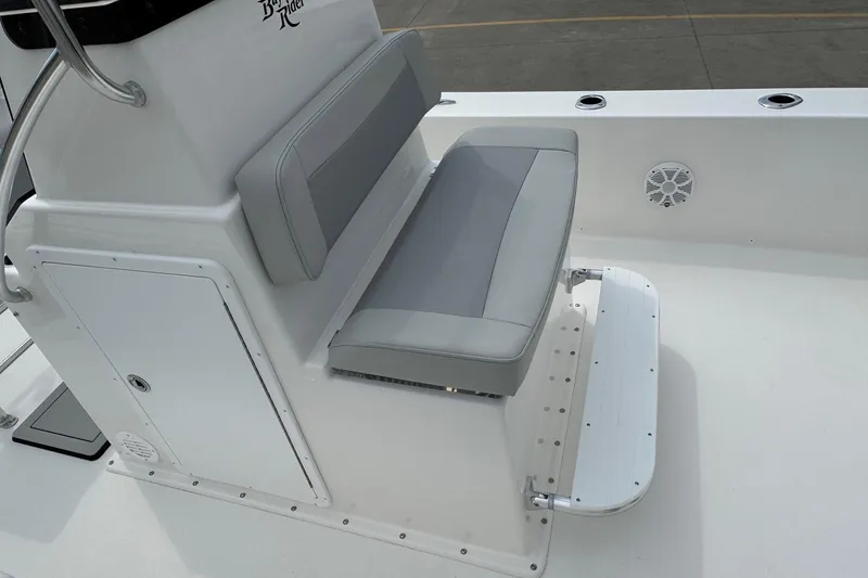 Slide: The Image of Bay Rider 2060 boat interior with gray seating and storage compartment, 2025 model. - 8