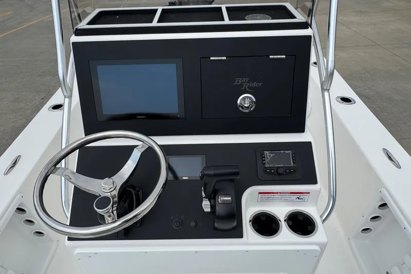 Slide: The Image of Center console of 2025 Bay Rider 2060 boat with steering wheel and navigation controls. - 14