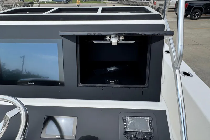 Slide: The Image of Bay Rider 2060 boat dashboard with Garmin display and open storage compartment, 2025 model. - 15