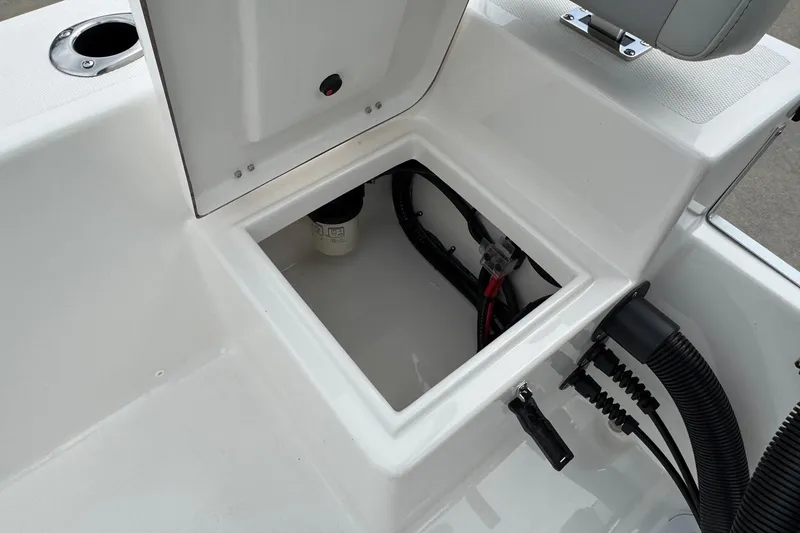 Slide: The Image of Open storage compartment in 2025 Bay Rider 2060 boat, showing wiring and components. - 18