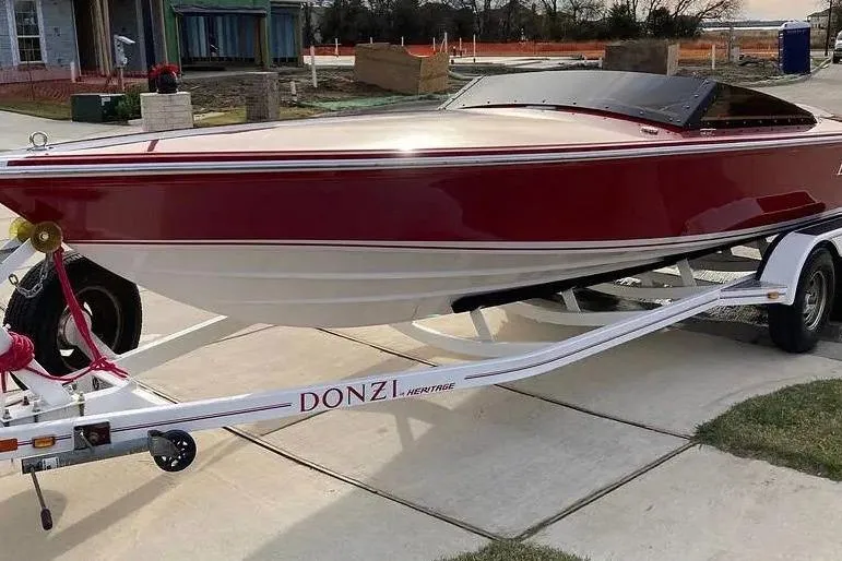 The Image of 2017 Donzi 22 Classic boat on trailer, red and white design, parked outdoors. - 0