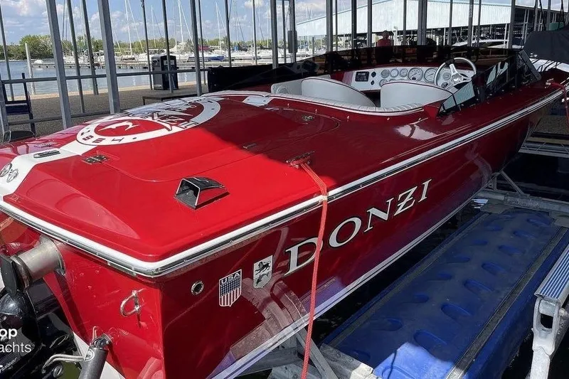 Slide: The Image of Red 2017 Donzi 22 Classic speedboat docked in a marina setting. - 13