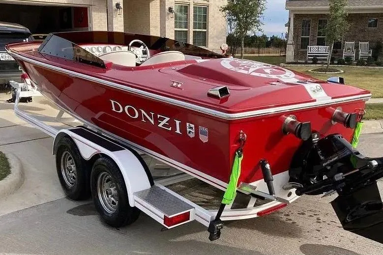 Slide: The Image of Red 2017 Donzi 22 Classic boat on trailer, parked in residential driveway. - 5