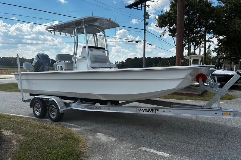 The Image of 2026 Bay Rider 2260 boat on trailer, parked outdoors under a partly cloudy sky. - 1