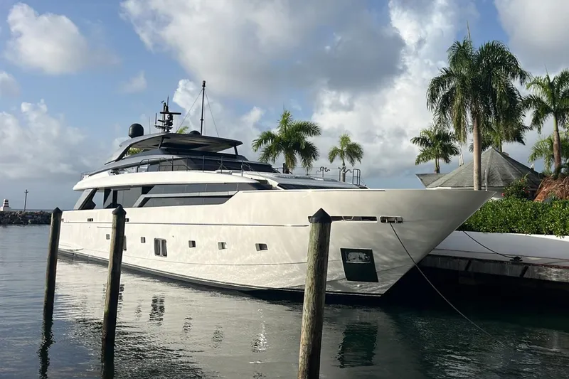 Slide: The Image of Luxury Sanlorenzo SL 120A yacht docked, 2022 model, surrounded by palm trees and calm water. - 2