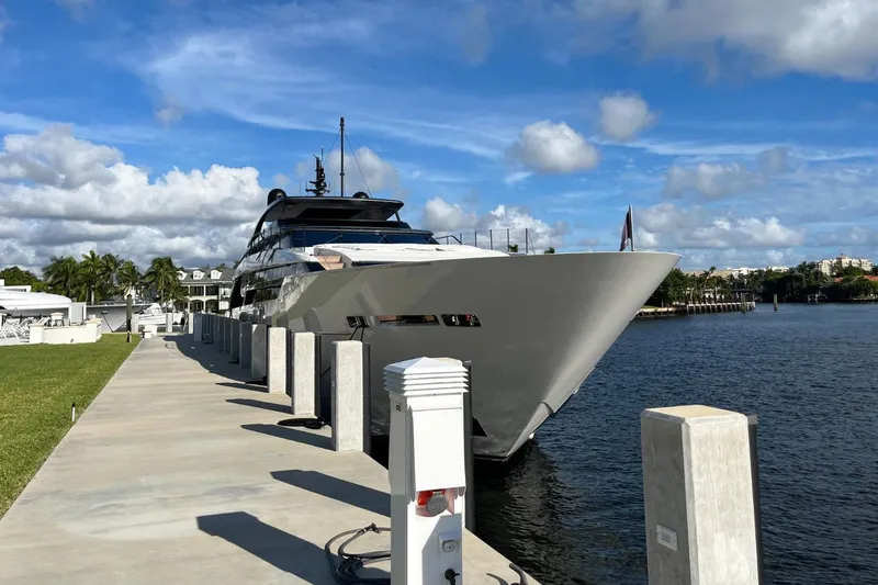 Slide: The Image of Sanlorenzo SL 120A yacht docked by the waterfront, 2022 model, under a clear blue sky. - 7