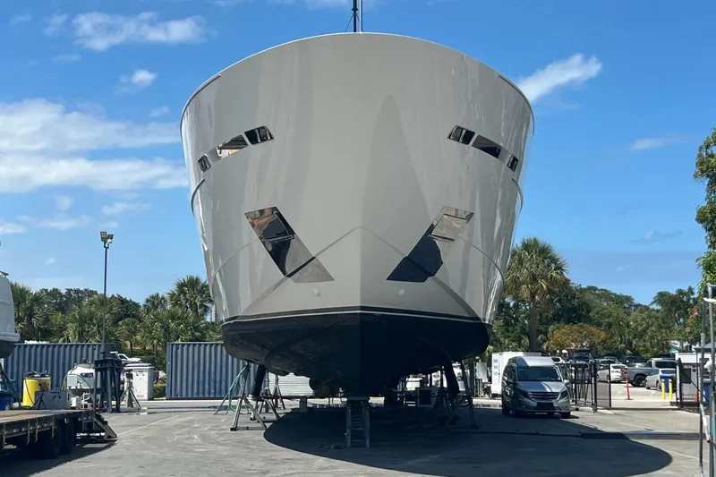Slide: The Image of Sanlorenzo SL 120A yacht, 2022 model, docked outdoors under a clear blue sky. - 8