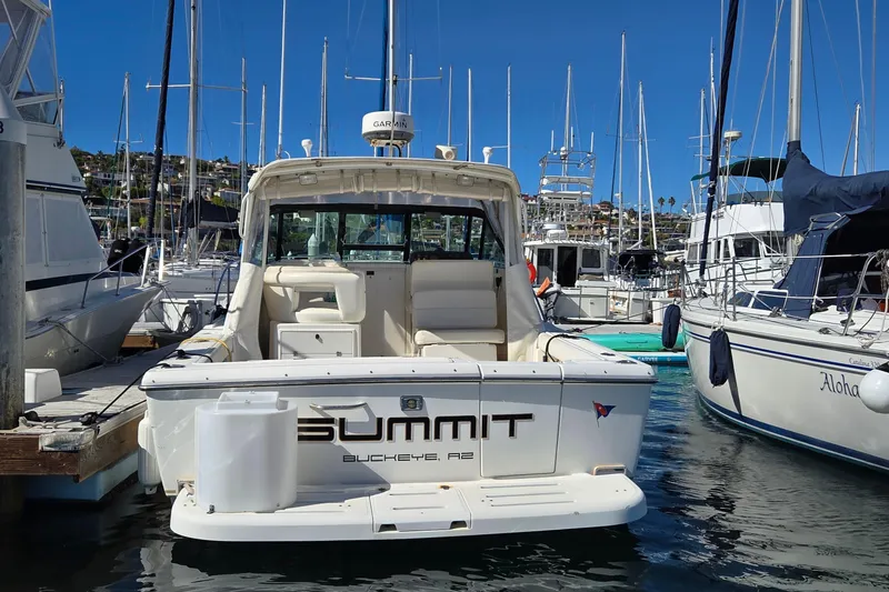 Slide: The Image of 2001 Tiara Yachts 2900 Open docked in a marina, surrounded by sailboats. - 2