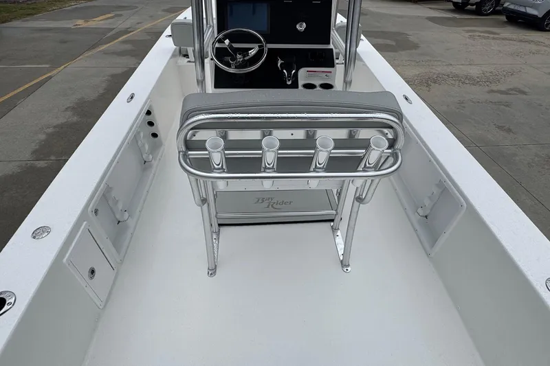 Slide: The Image of 2026 Bay Rider 2260 FS boat interior with steering console and rod holders. - 13