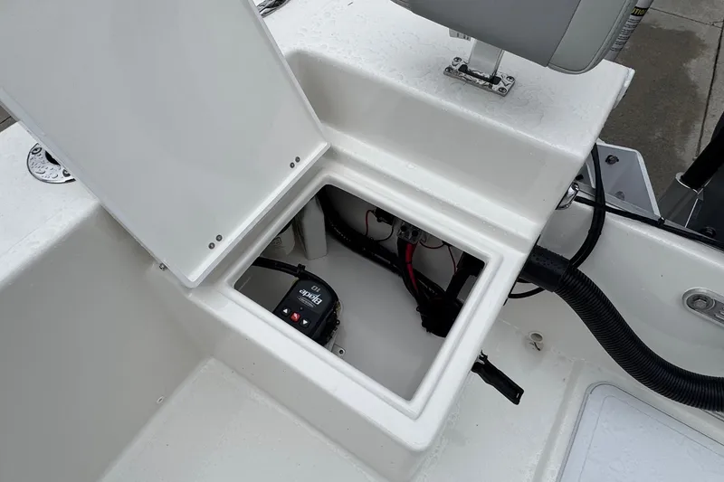 Slide: The Image of Open storage compartment on 2026 Bay Rider 2260 FS boat, showing internal wiring and equipment. - 16