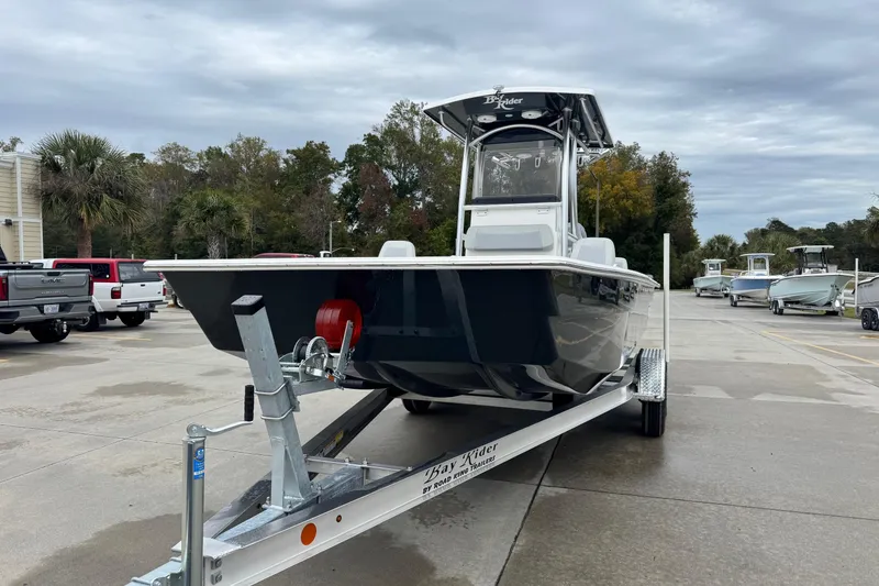 Slide: The Image of 2026 Bay Rider 2260 FS boat on trailer in parking lot, cloudy sky background. - 2