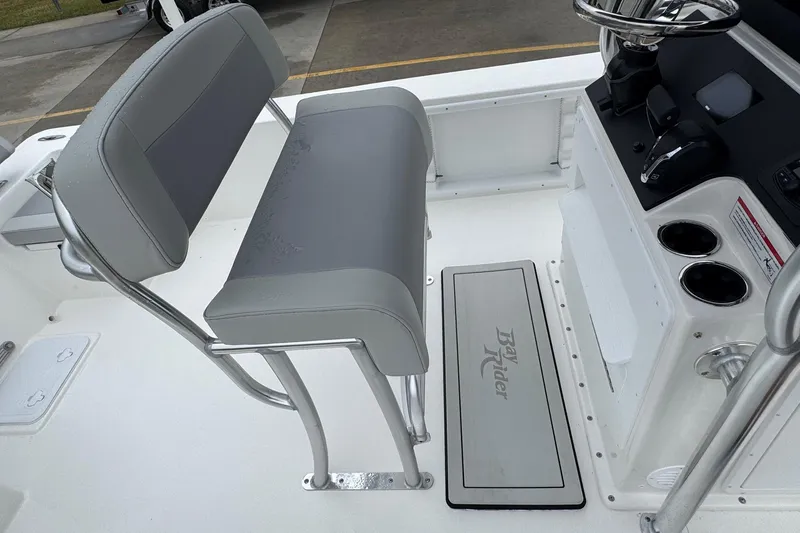 Slide: The Image of 2026 Bay Rider 2260 FS boat interior with gray seating and console. - 21