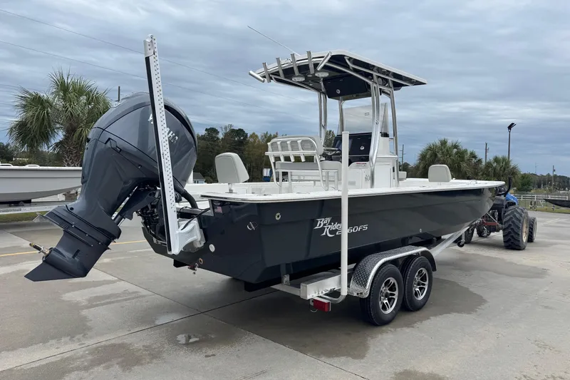 Slide: The Image of 2026 Bay Rider 2260 FS boat on trailer, parked outdoors under cloudy sky. - 3