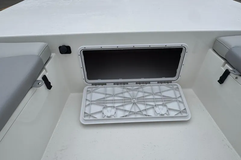 Slide: The Image of Open storage compartment on 2026 Bay Rider 2260 FS boat, featuring cushioned seating. - 8